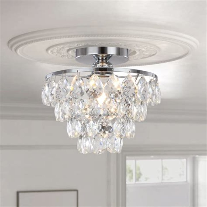 A chandelier from the top deck reaches down to the lower deck and marble floors