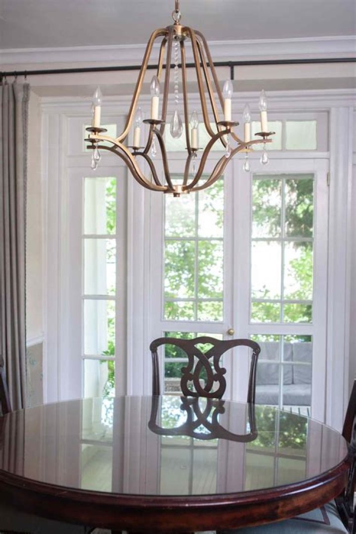 A chandelier hangs from a ceiling of gold