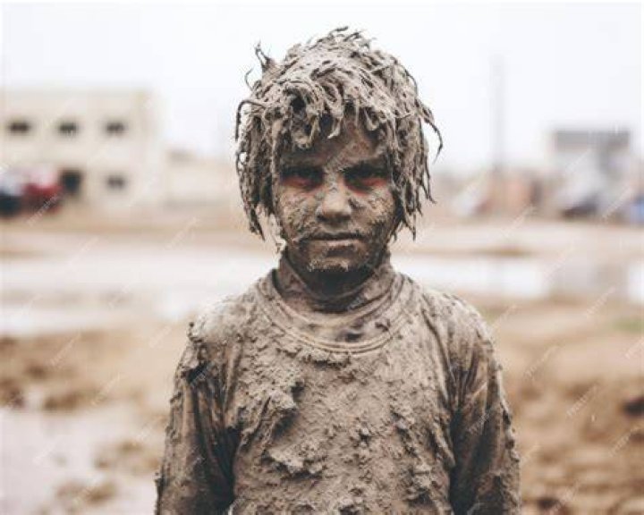 A child is covered in blood after they were cut during a religious procession