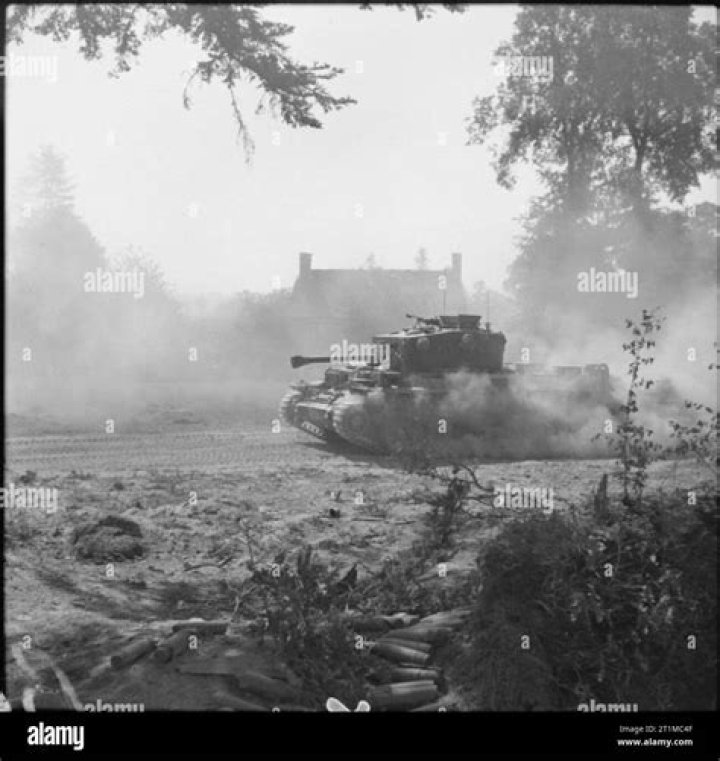  A Cromwell tank advances through the rubble of Udem.