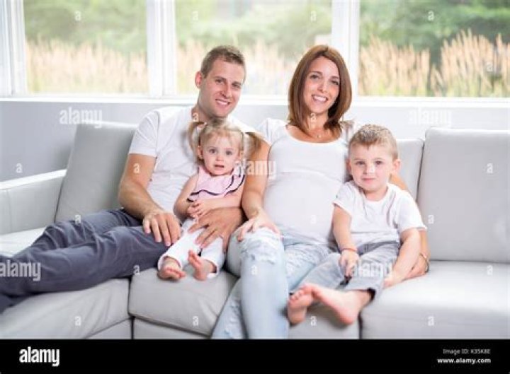 A family sits on the bed of a pickup truck