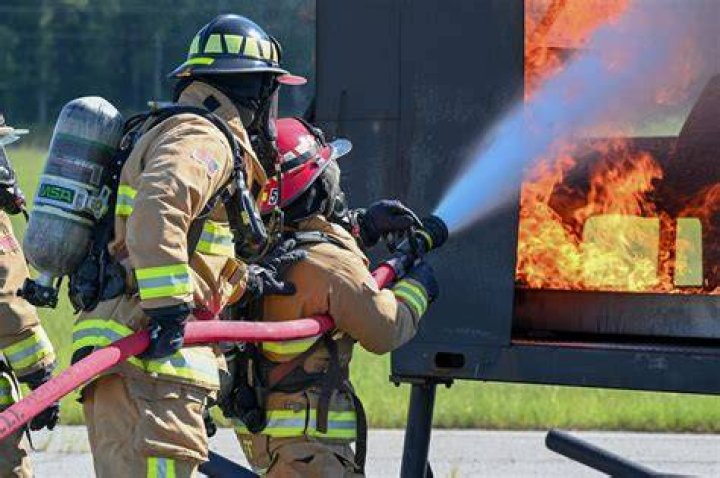 A firefighter works on hotspot at a wildfire in Yucaipa, California
