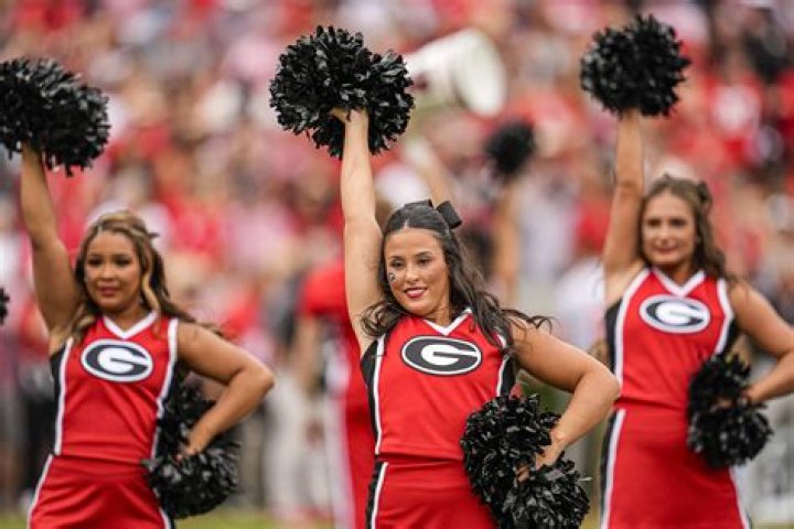  A Georgia cheerleader lies on the court after falling during a routine
