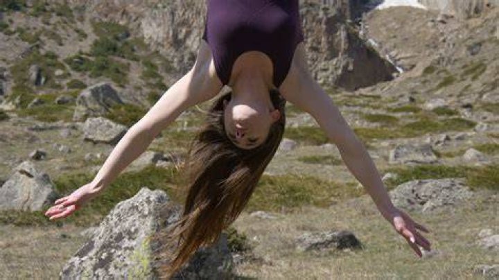 A girl downs shots upside down
