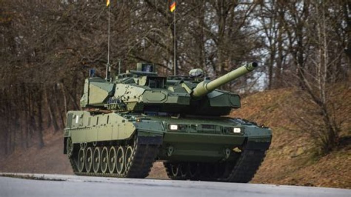 A Leopard 2 main battle tank drives past Albanian and British vehicles during a Nato military exercise on Monday