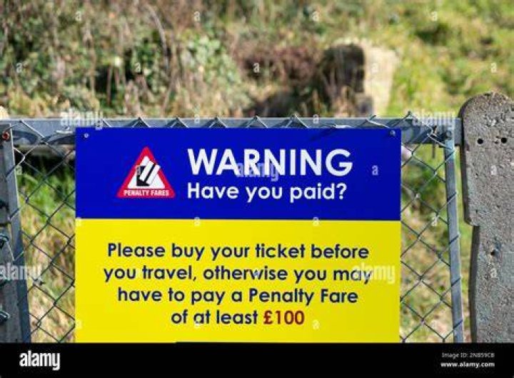A warning sign displays fines for consuming alcohol in public
