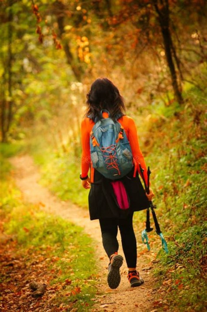 A woman makes her way down 5th Street Hill passed downed trees and telephone lines&nbsp;in West Virginia