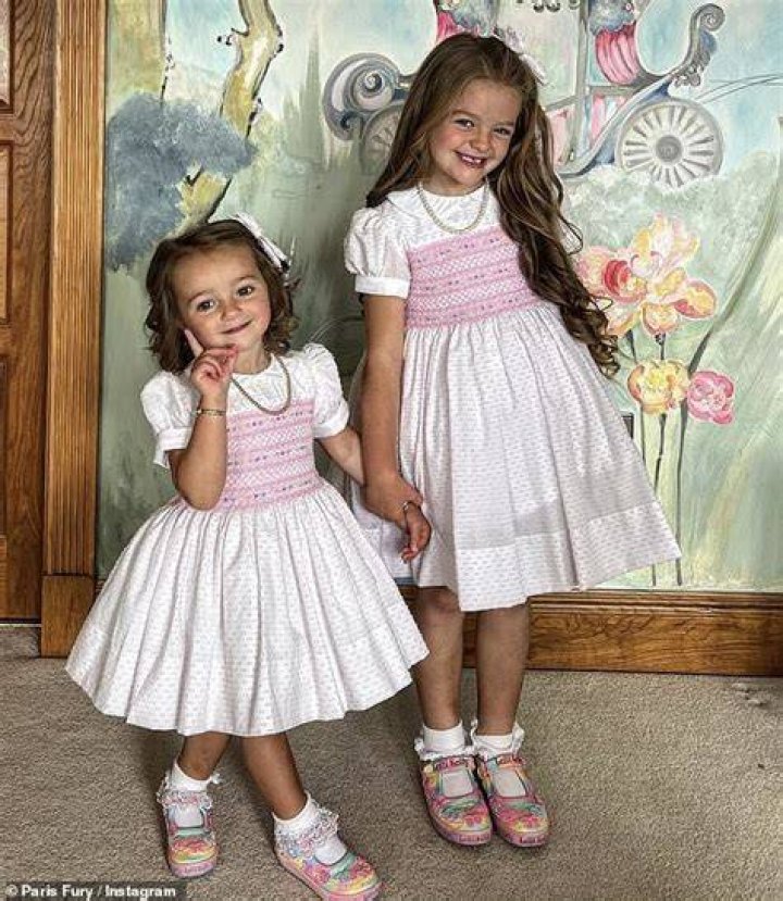 Adorable Athena and Valencia in matching white and pink dresses