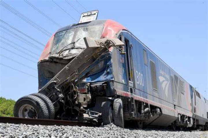 Amtrak said the train derailed after hitting a dump truck at a public crossing