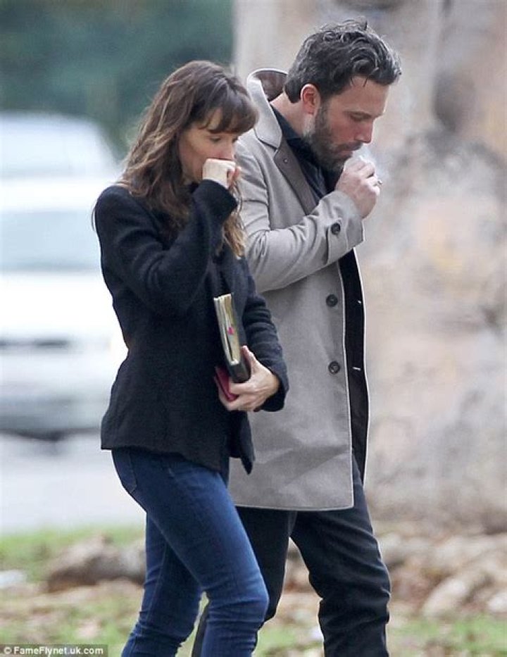 Ben lights up a cigarette while walking with J-Lo in 2002 in New York City