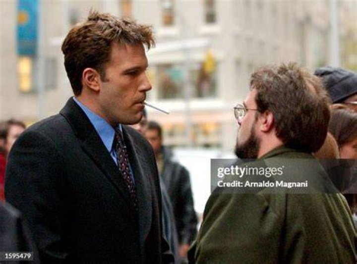Ben smokes a cigarette listening to directions from director Kevin Smith on the set of Jersey Girl in 2002
