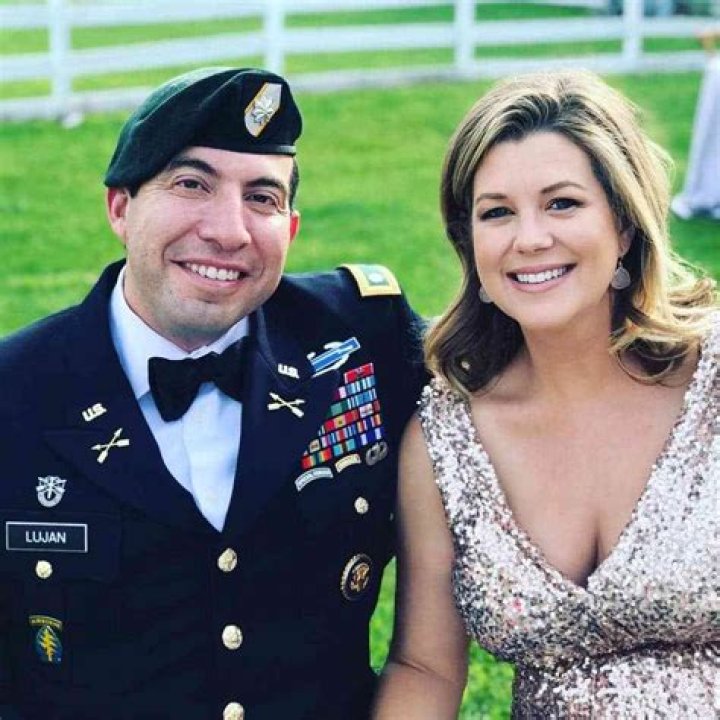 Brianna Keilar and her husband Fernando Lujan pose for a photo with Wolf Blitzer