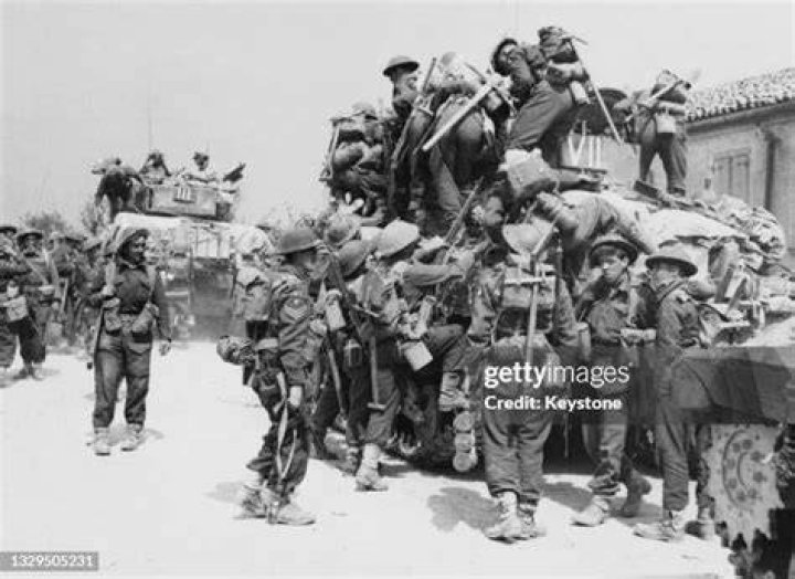  British infantrymen climb aboard a 79th Armoured Division an allied tank as they fought to cross the Rhine