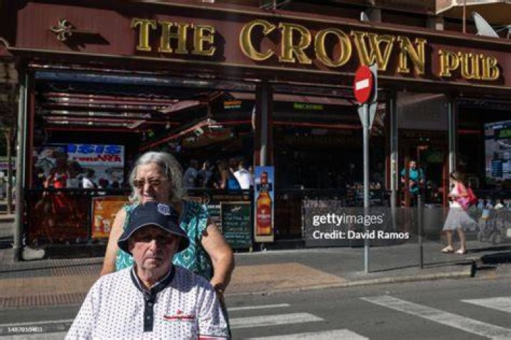 British tourists walk past the Tiki Beach bar on Levante beach in Benidorm (stock picture)
