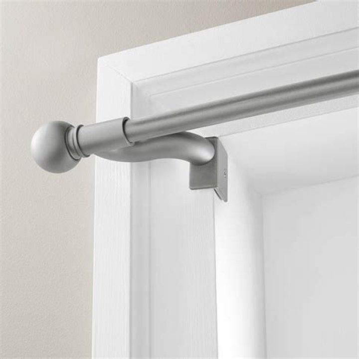 Broch hung extendable curtain rods on each side of the balcony so the couple could hang curtains