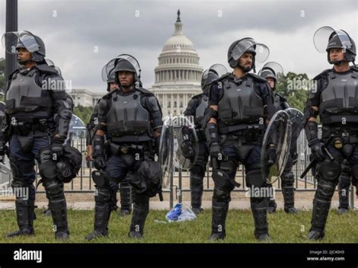Capitol Police officers near a car that crashed into a barrier on Capitol Hill in Washington