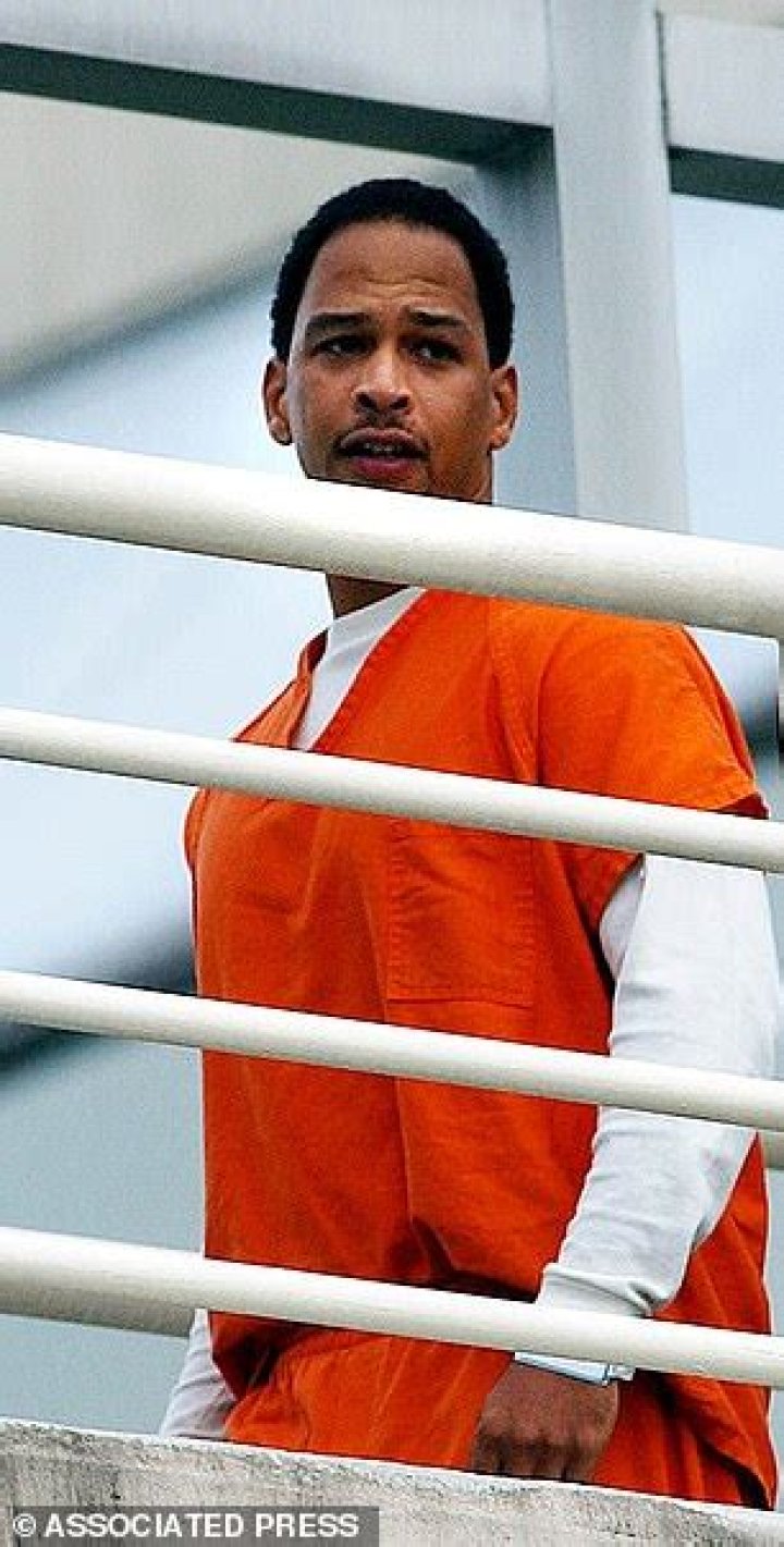 Carruth is pictured being escorted into police custody