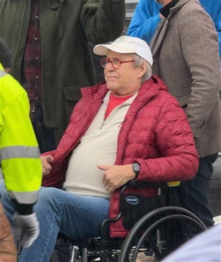 Chevy covered his head with a white cap and had on red-rimmed glasses
