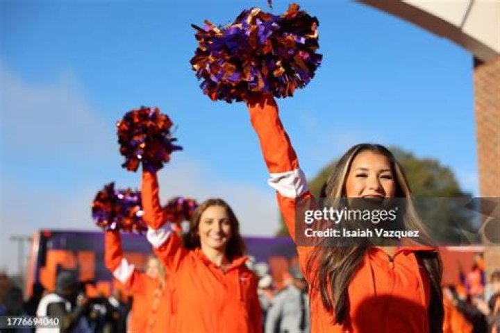  Clemson Tigers cheerleaders perform a stunt in 2018
