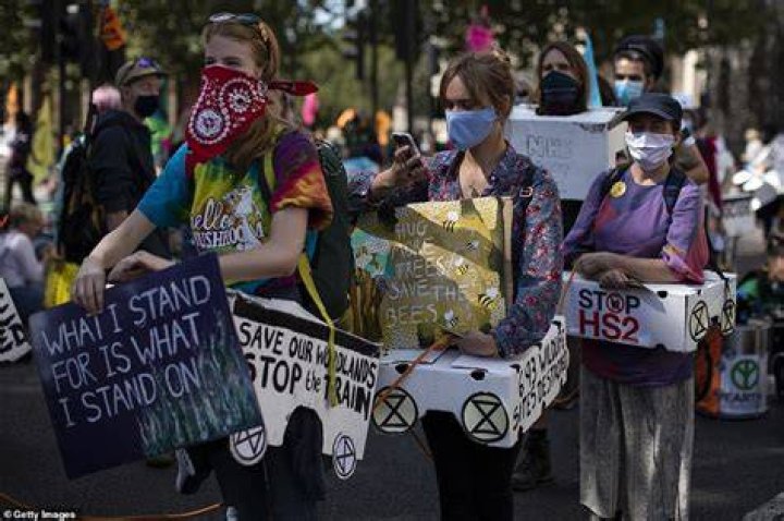 Demonstrators clutch signs as they march through London