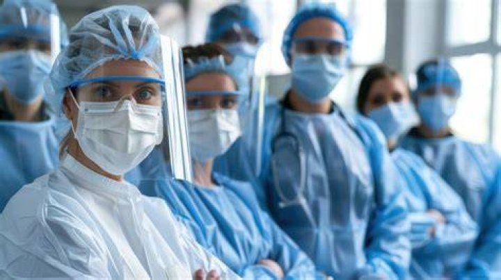 Doctors and relatives wearing protective gear carry the body of a victim during a Nipah virus outbreak in 2018 (STOCK)