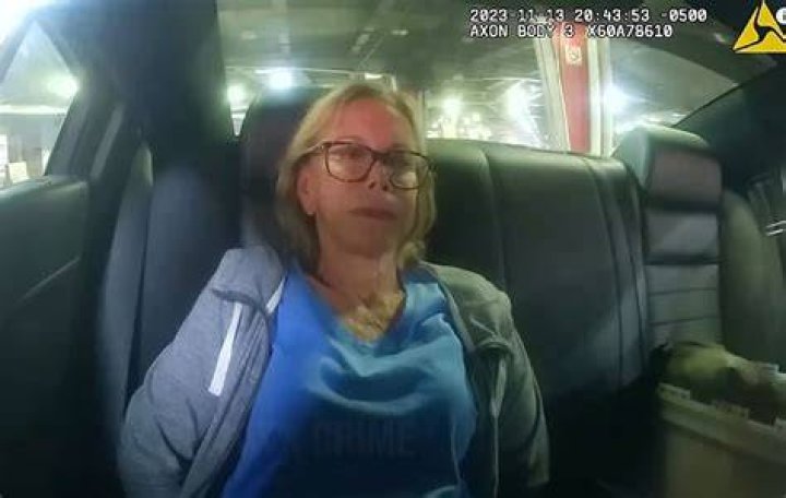 Donna sat quietly in the police car during the arrest