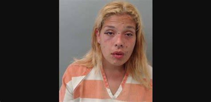 Erika Pena shows how Ortiz, held a gun to her, as she testifies during his trial