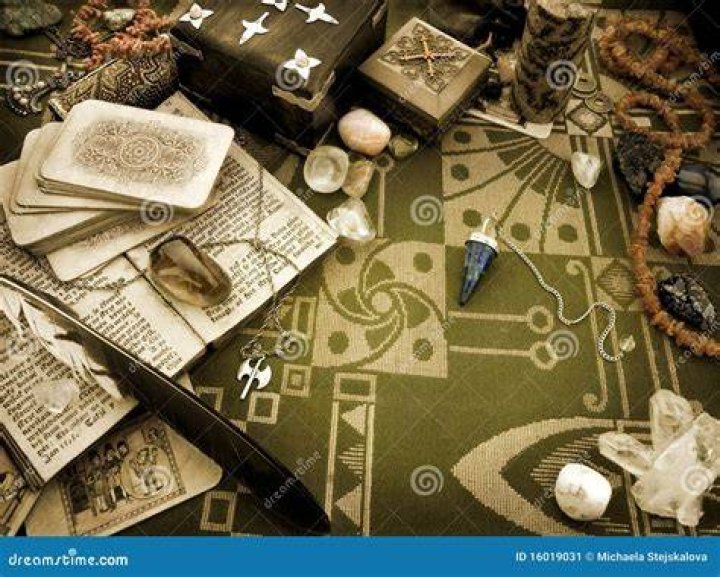 Esoteric still life with the Tarot cards, candle, mirror and crystals