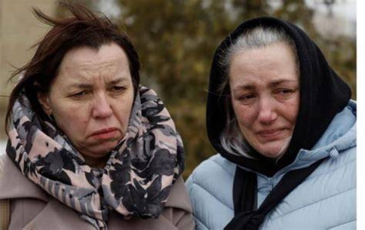 Family members and neighbours grieve at the scene