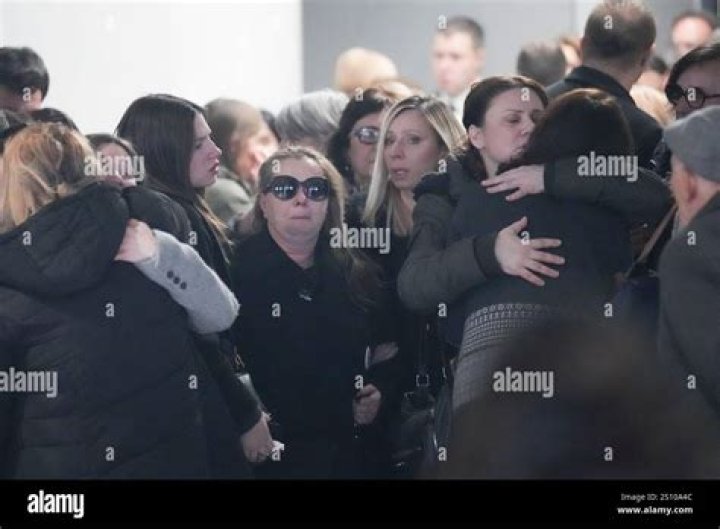 Friends of the victims react after laying flowers at the scene