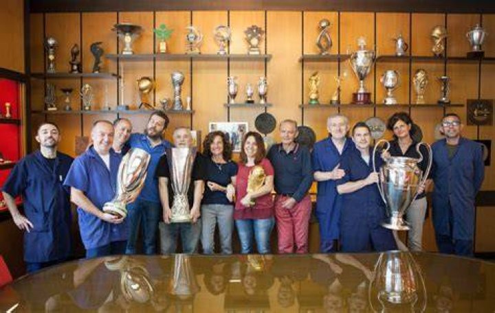 GDE Bertoni staff display the trophies they've created through the years