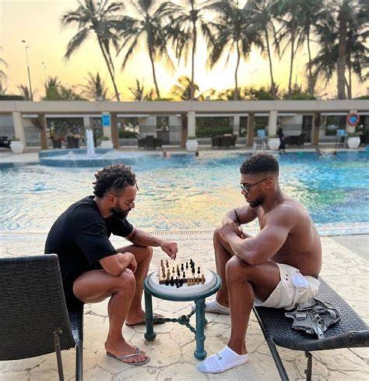 Globetrotter Anthony Joshua enjoys five-star holidays with his entourage inbetween tough training sessions - enjoying a game of chess with a pal