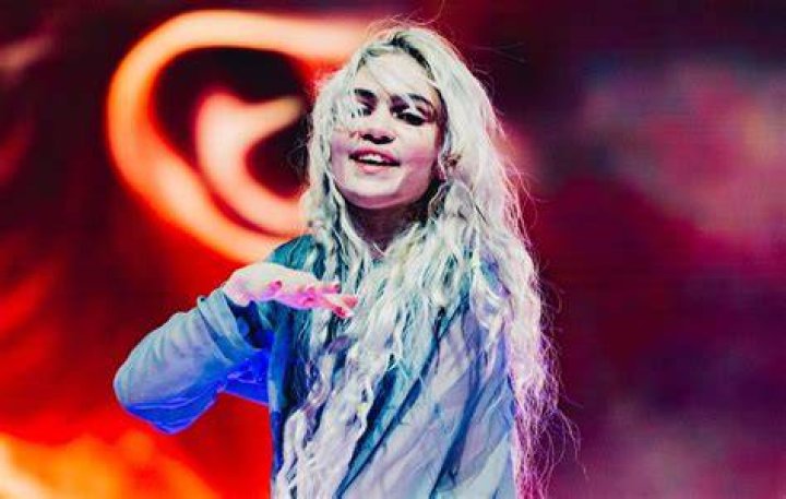 Grimes donned a blue cap over her light purple hair