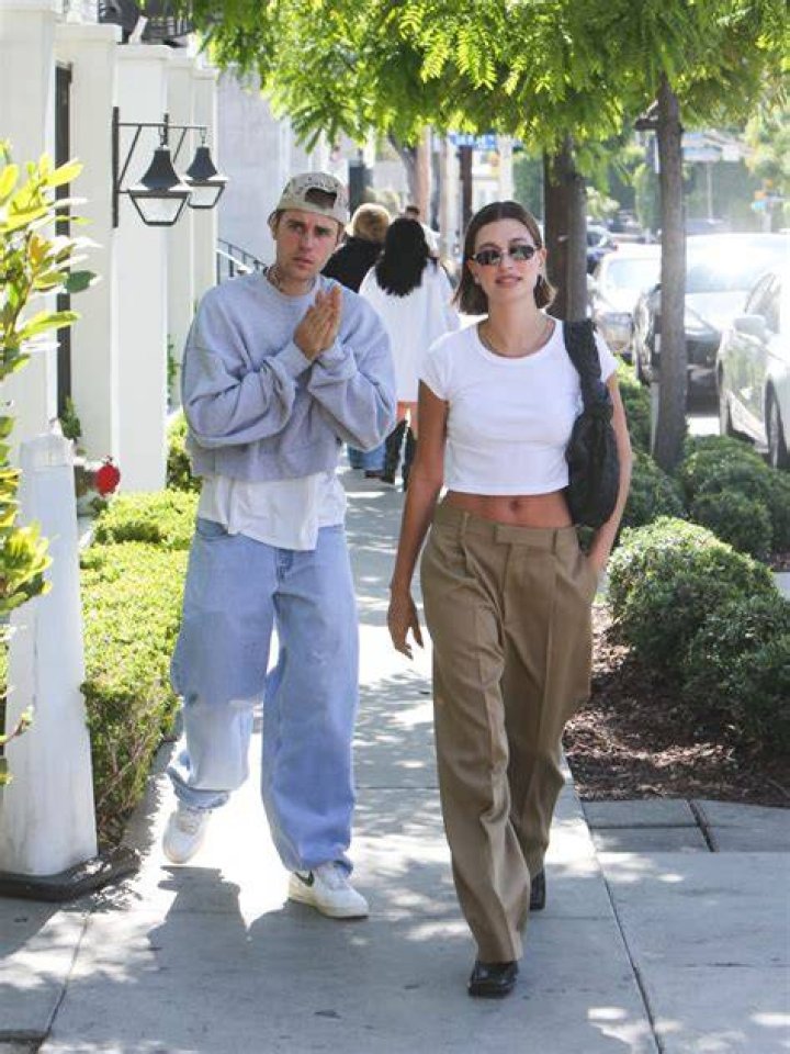 Hailey still gets caught placing her arms over her middle as she had them in the video