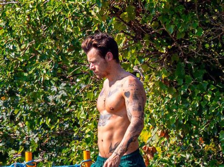 Harry showing off his tattoos