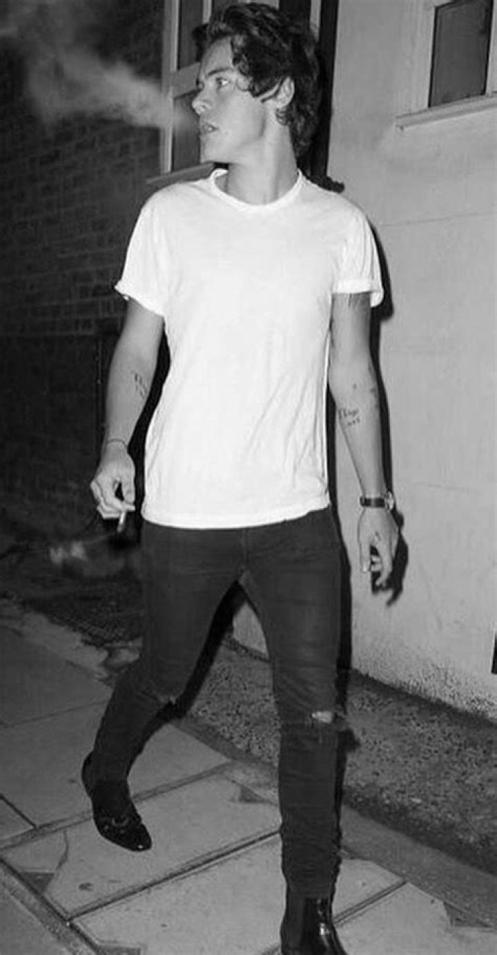 Harry Styles smokes a cigarette on Brighton beach as he films scenes for the drama