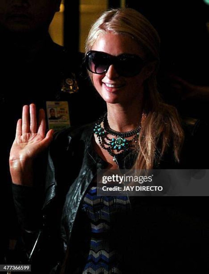 Heiress Paris Hilton waves during a party at downtown club L