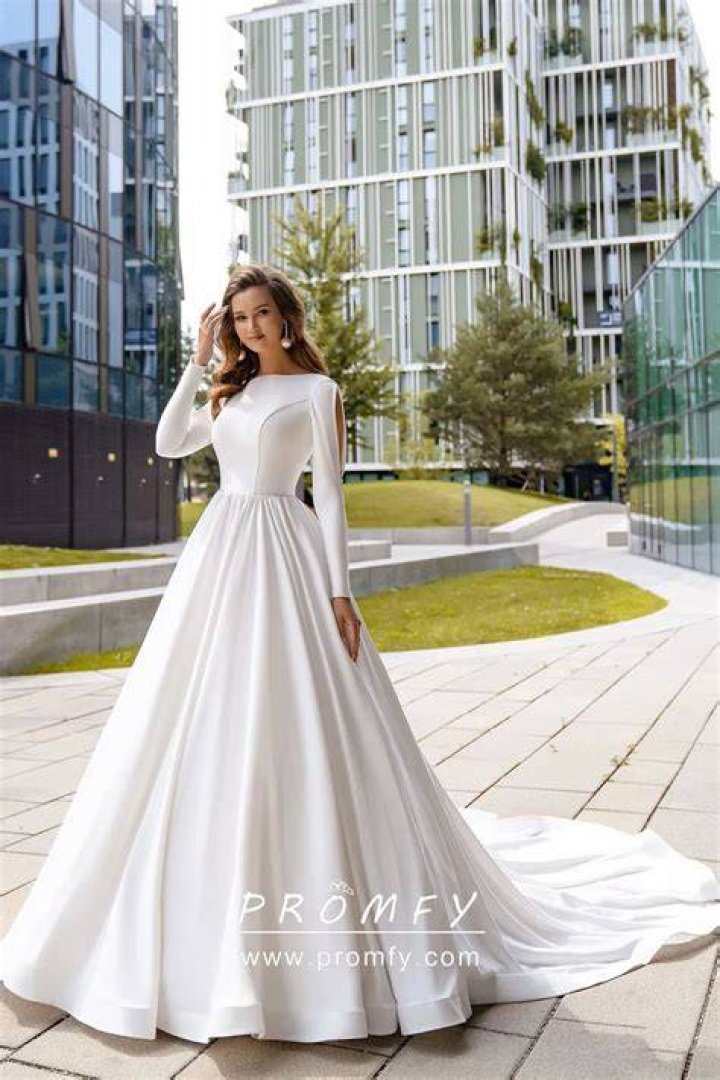 Her dress featured long sleeves, a long skirt, and fold-over detail that covered her cleavage