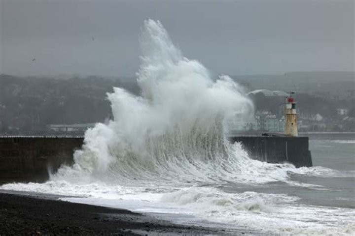 Huge waves crash into the seafront at Lyme Regis, Dorset, today