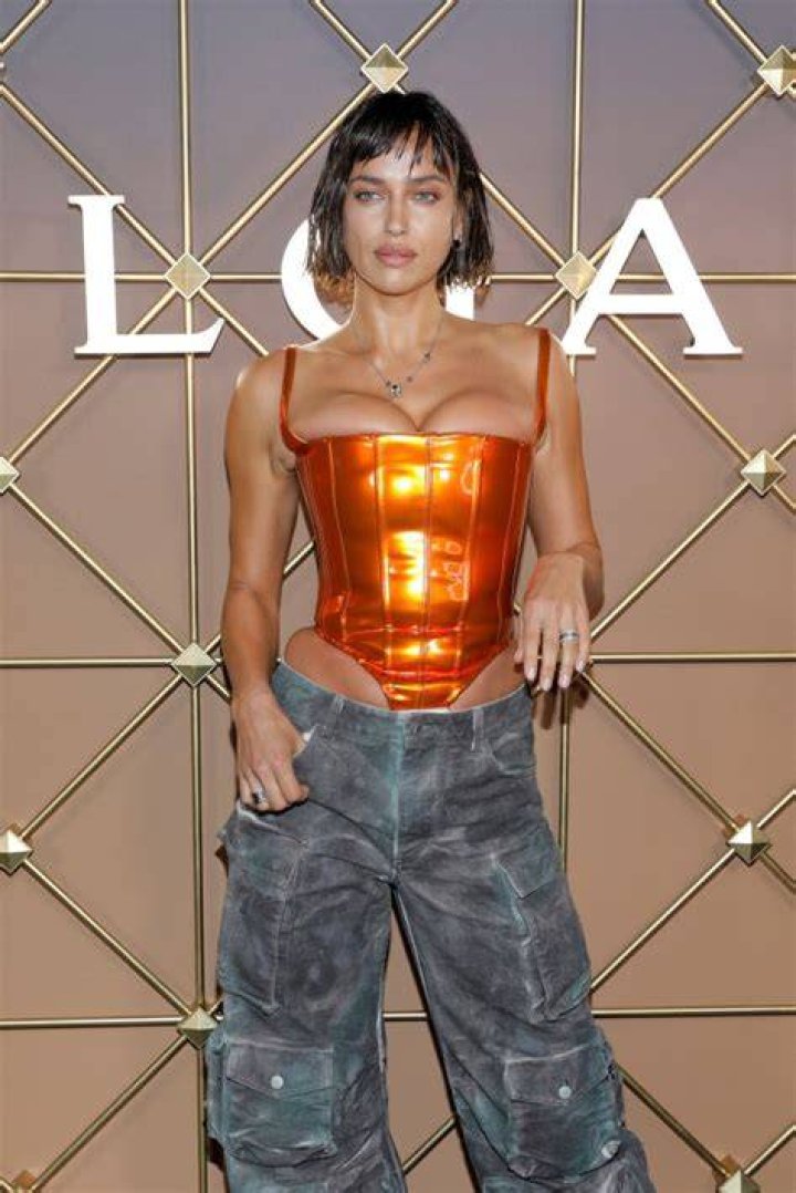 Irina sported a tight metallic orange corset and some combat pants