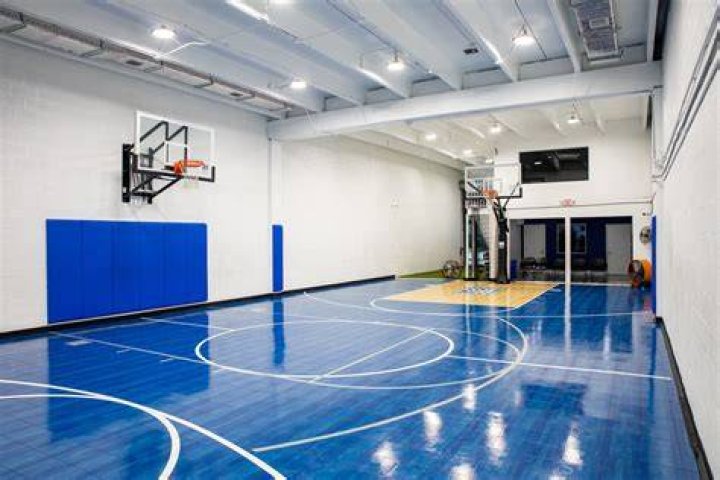 It features an indoor basketball court and a batting cage