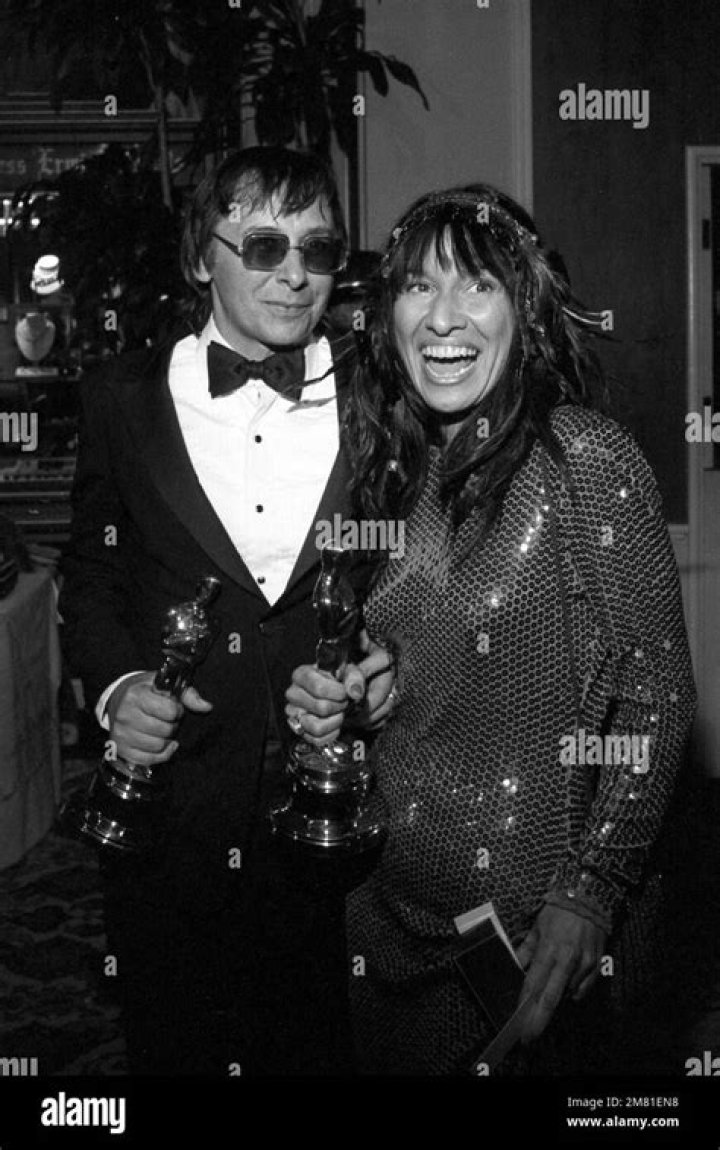Jack Nitzsche and singer Buffy Sainte Marie are pictured holding their Oscar for Best Song at the Academy Awards in Los Angeles, California, in 1983