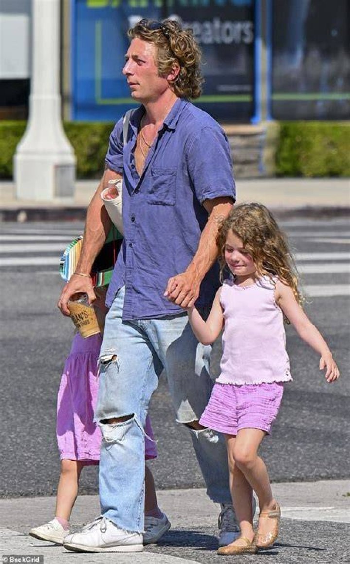 Jeremy played with his daughters on the swing set