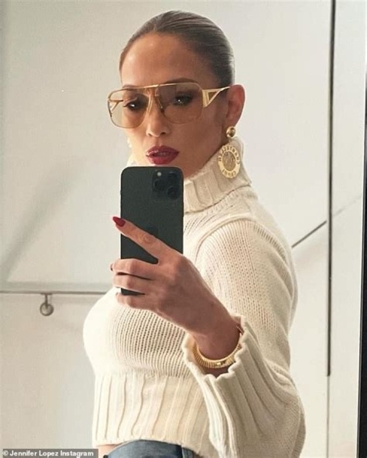 JLo snapped selfies on her phone as she posed sultrily at the camera