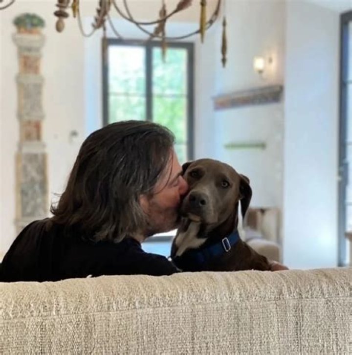 John gave their dog, Belle Boo Blue, a kiss on the cheek, as Rachael posted about Nutrish dog food