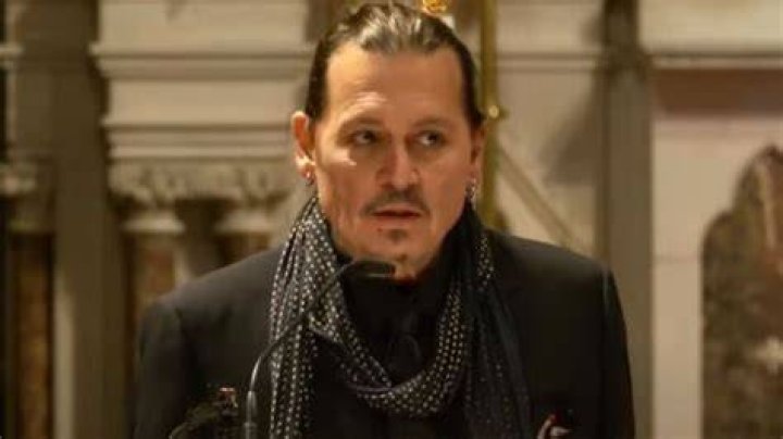 Johnny Depp delivers a reading during the mass