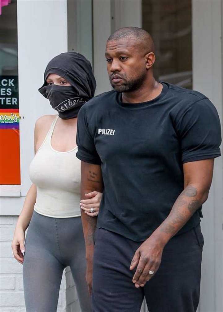 Kanye walked around the store with his mask on