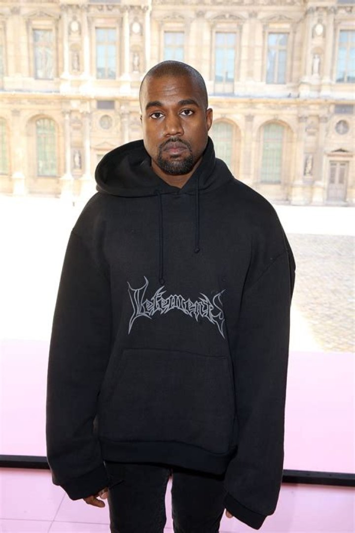 Kanye was wearing an oversized all-black outfit with no shoes