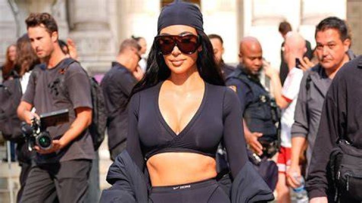 Kim Kardashian poses in the new boyfriend tank top as she stands in her walk-in closet