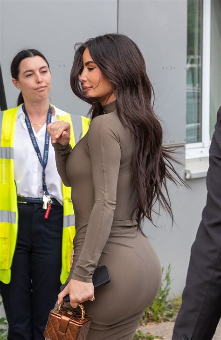 Kim Kardashian wore an olive Dior wrap mini-dress as she partied in Miami on Friday
